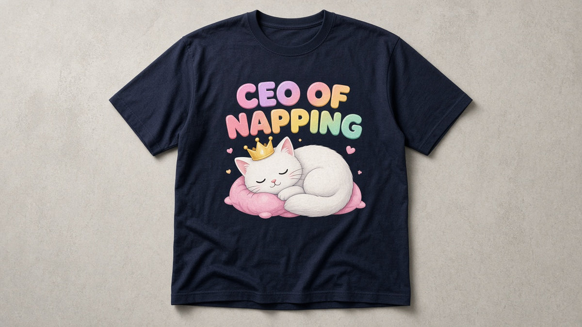 Navy CEO of Napping tee with pink-to-yellow bubble letters and crowned sleepy cat